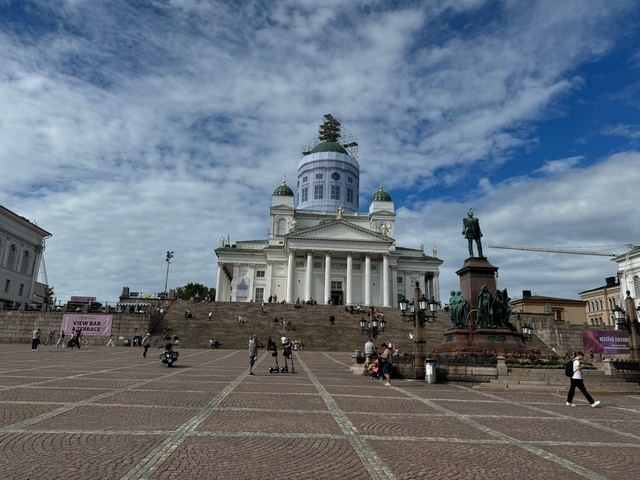 Grand neoclassical cathedral with people walking around.