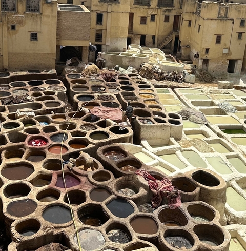       Traditional tanneries with stone vats and colorful dyes.
  