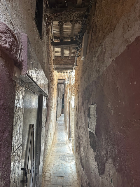       Narrow alleyway with rustic walls.
  