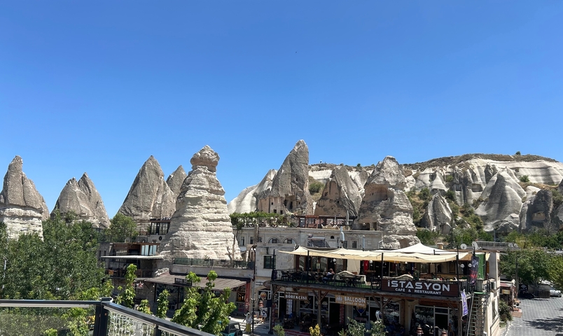       Rocky spires and structures with a restaurant at the base.
  