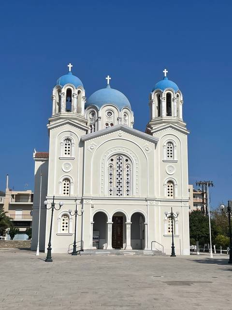       Church with blue domes under a clear sky.
  