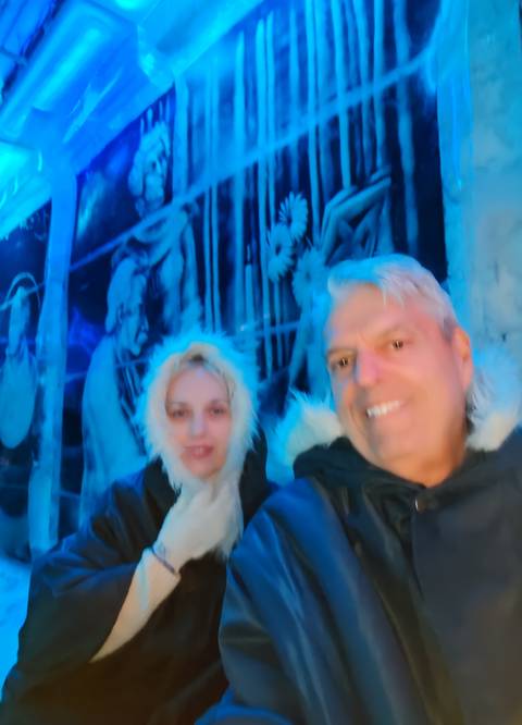 Blurry image of two people in winter clothing.