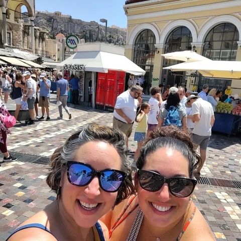 Crowded street market with various people shopping.