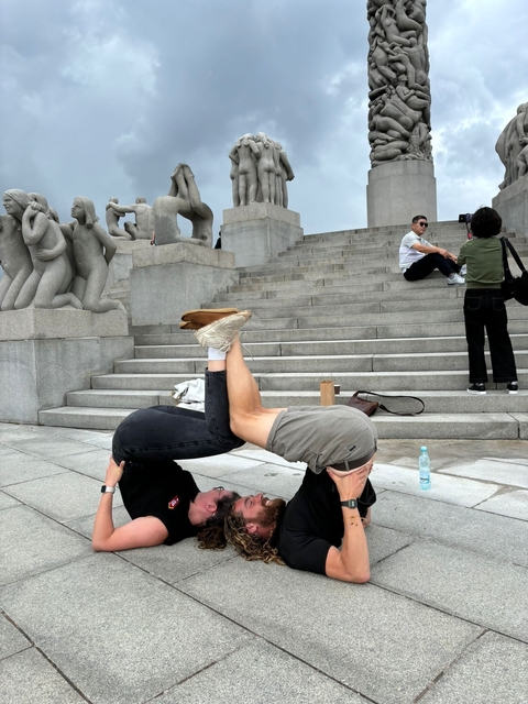       People interacting on the steps of a sculptural park.
  