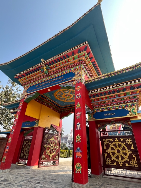       Decorative temple spire against a clear blue sky.
  