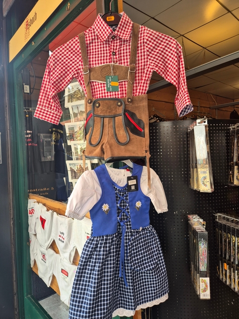 Children's traditional costumes on display in a shop.