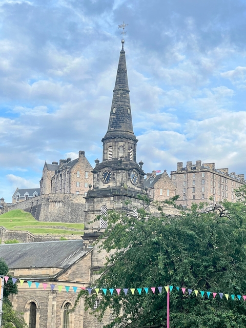       Historic building with clock tower in Edinburgh.
  