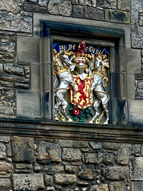       Coat of arms on a stone building.
  