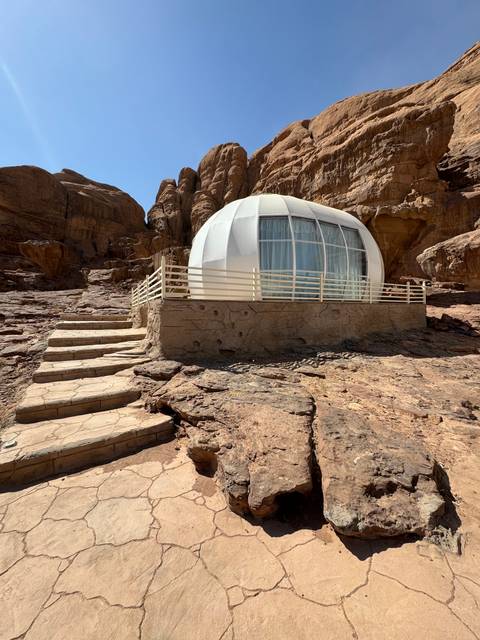 Modern dome accommodation in rocky landscape.