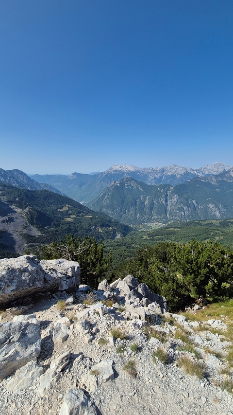 Expansive mountain range with lush valleys.
