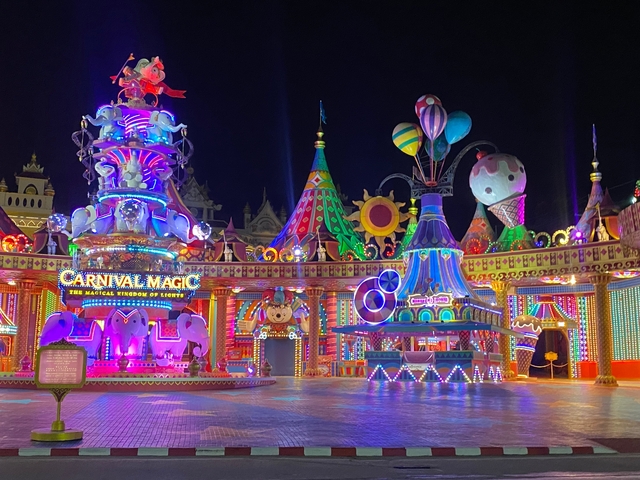       Vibrant carnival setting at night.
  