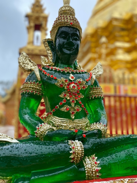       Colorful ornate sculpture in a temple setting.
  