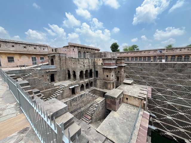 Step-well or ancient structure with intricate stone masonry.