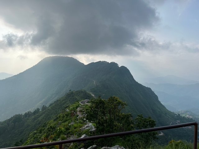 Mountainous landscape under a cloudy sky.
