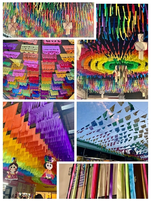       Colorful festive decorations hanging in an open space
  