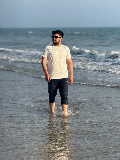 Person enjoying the sea near the shore