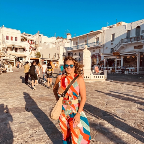       Tourist smiling in a lively Mediterranean street
  