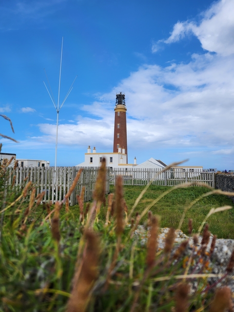 Lighthouse with a backdrop of blue sky.