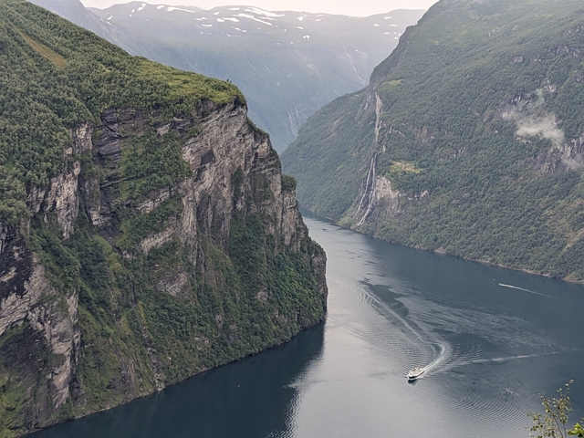 Majestic fjord with steep cliffs and a boat.