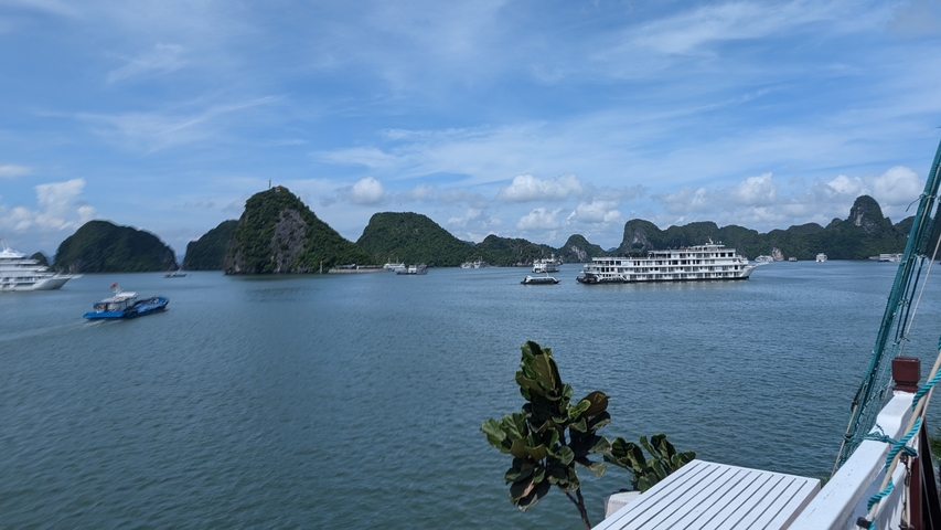 Boats in a bay with limestone cliffs.