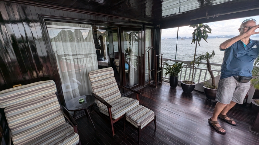 Person on a boat deck with scenic views.