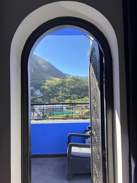       View of mountains through decorated window
  