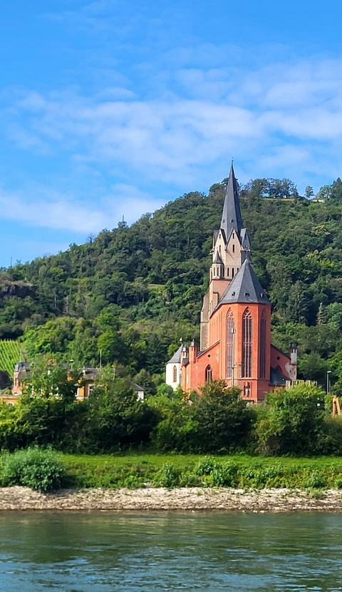       Red brick church with pointed steeple.
  