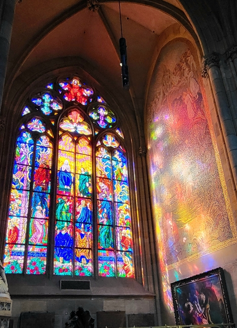       Stained glass windows inside a cathedral.
  