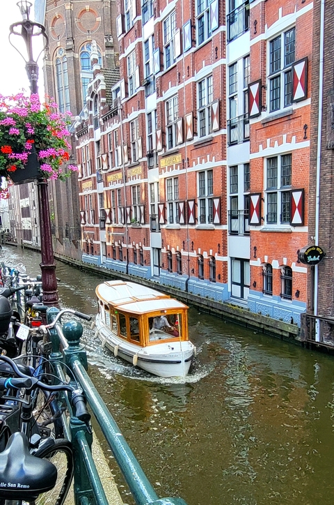 Traditional canal houses with a boat in Amsterdam.