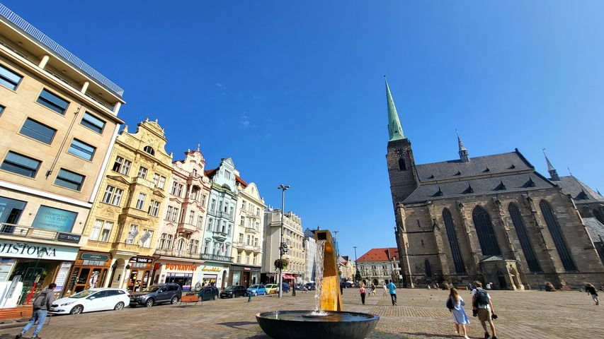       City square with historic buildings and a church.
  