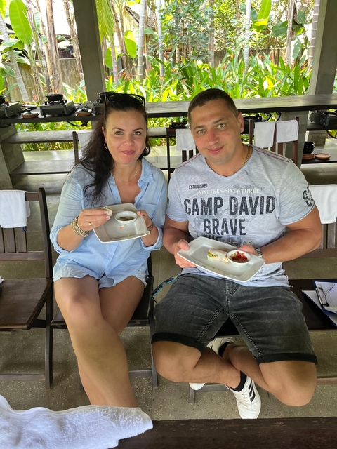      Two people enjoying a meal at an outdoor setting.
  