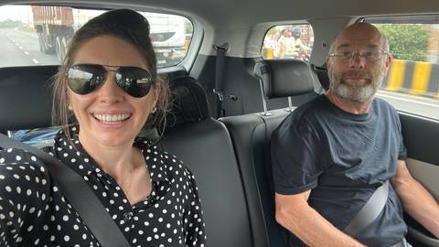       Couple taking a selfie in a car.
  