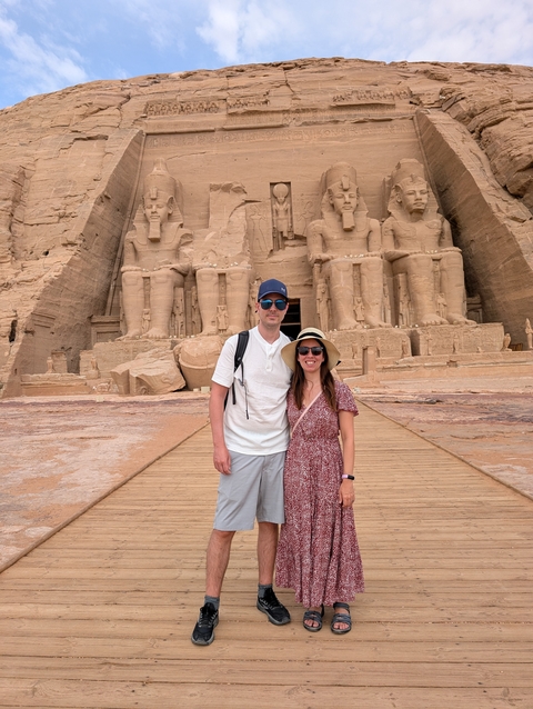 Tourists posing in front of the Abu Simbel temples in Egypt.
