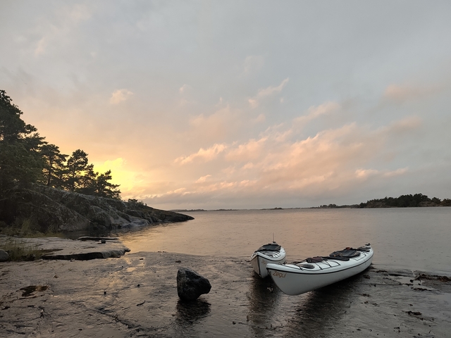 Kayak on the shore during a beautiful sunset.