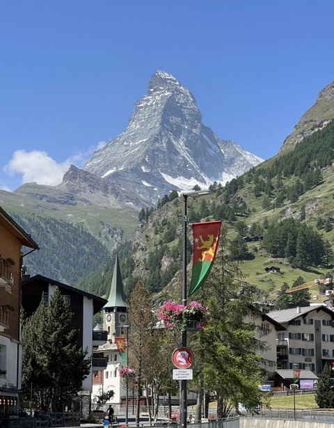 Mountain landscape with a flag and part of a village.