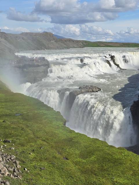 Waterfall with a rainbow visible above the falls.