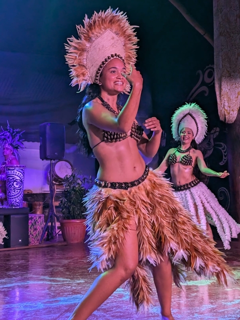       Female dancers in traditional attire on stage.
  