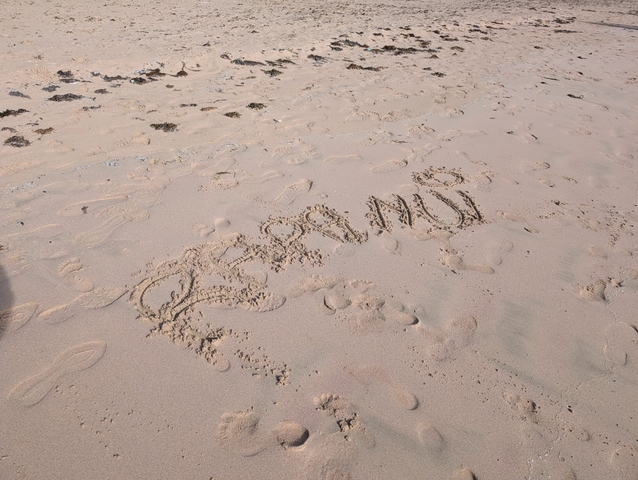       Words written in the sand among footprints.
  