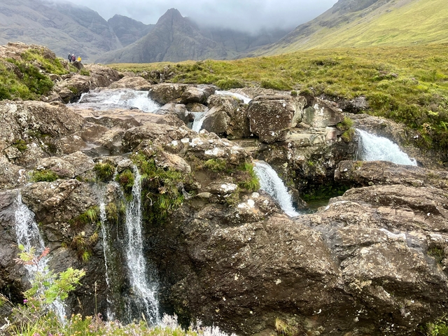 Rocky terrain with a series of small waterfalls.