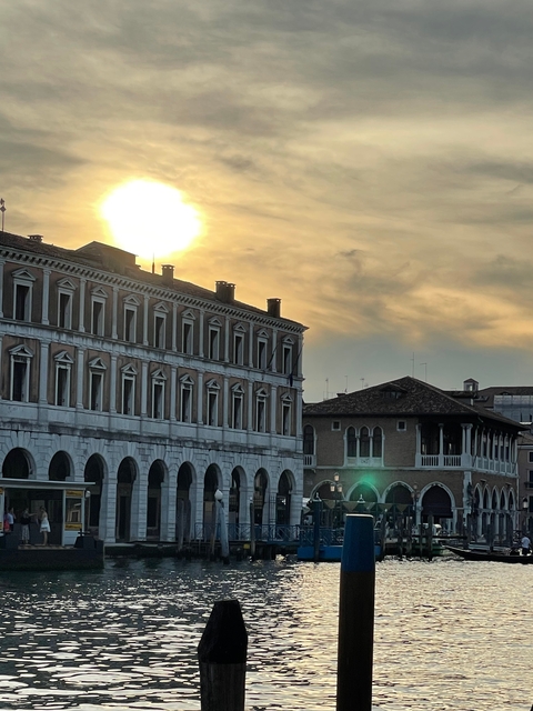       Buildings with ornate architecture with the sun setting.
  