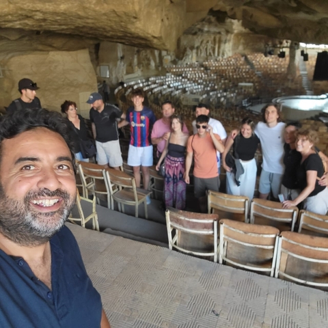 Group of people posing inside an ancient theater.