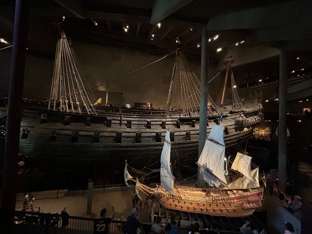       Interior of museum with historic ships in exhibition.
  