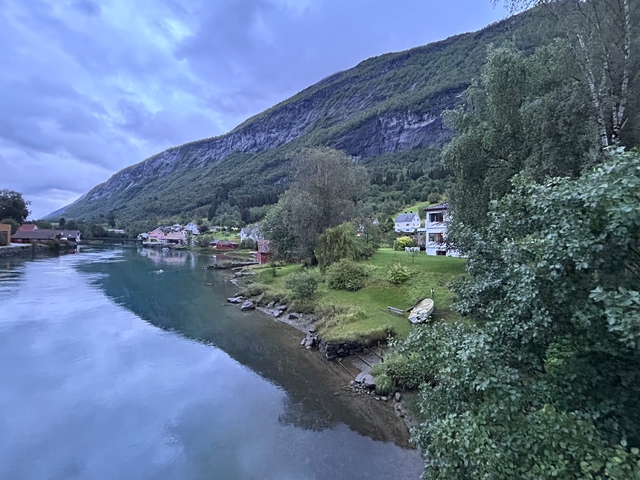       Small village by a river amidst mountains.
  