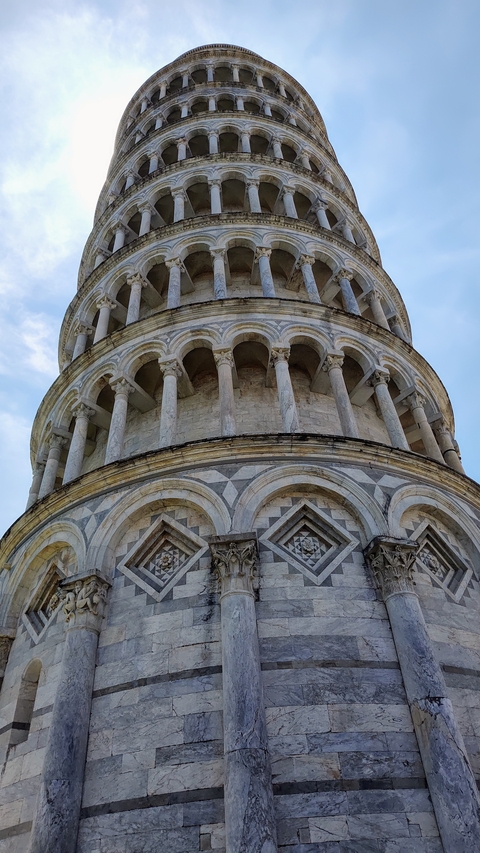 Close-up of the Leaning Tower of Pisa's intricate architectural details.