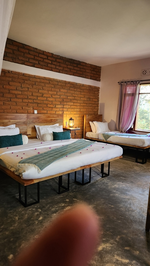 Interior of a room with two beds and wooden decor.