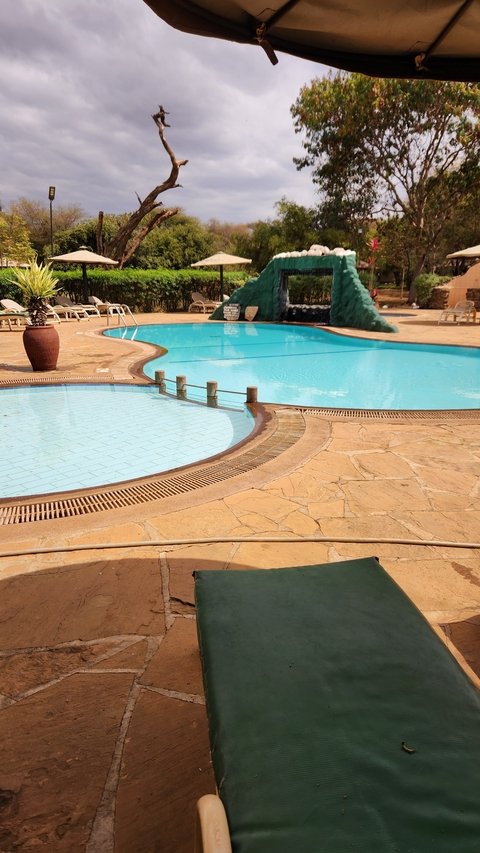 Swimming pool area with sun loungers.
