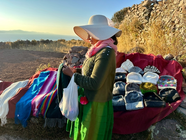       Woman selling knitted items outdoors.
  