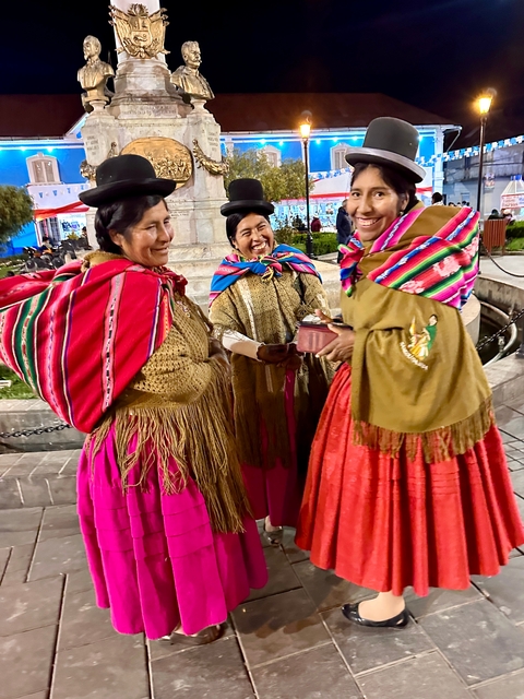       Women in traditional attire laughing together.
  