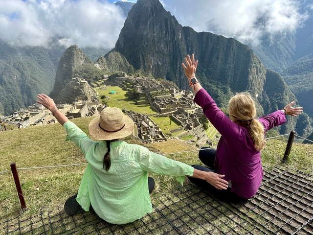       Two women enjoying the view of Machu Picchu.
  