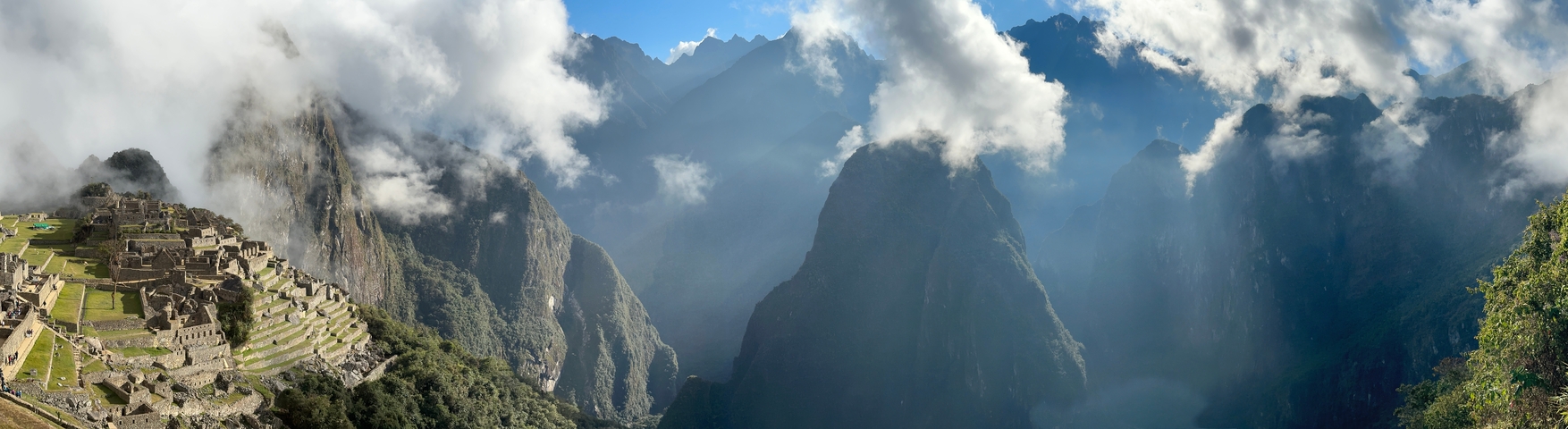       Mountainous landscape with misty clouds and dramatic lighting.
  